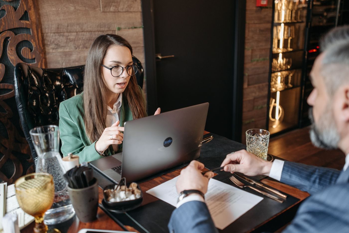 Advisor assisting a client with a laptop during an office meeting