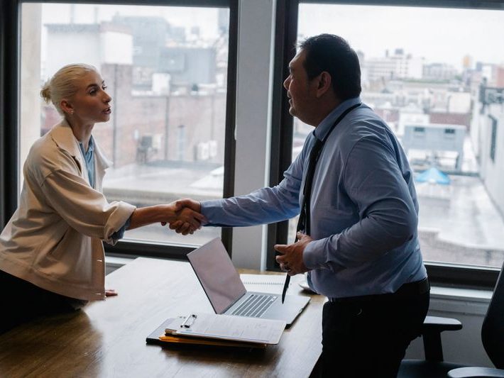 Advisor and client shaking hands after setting up a company